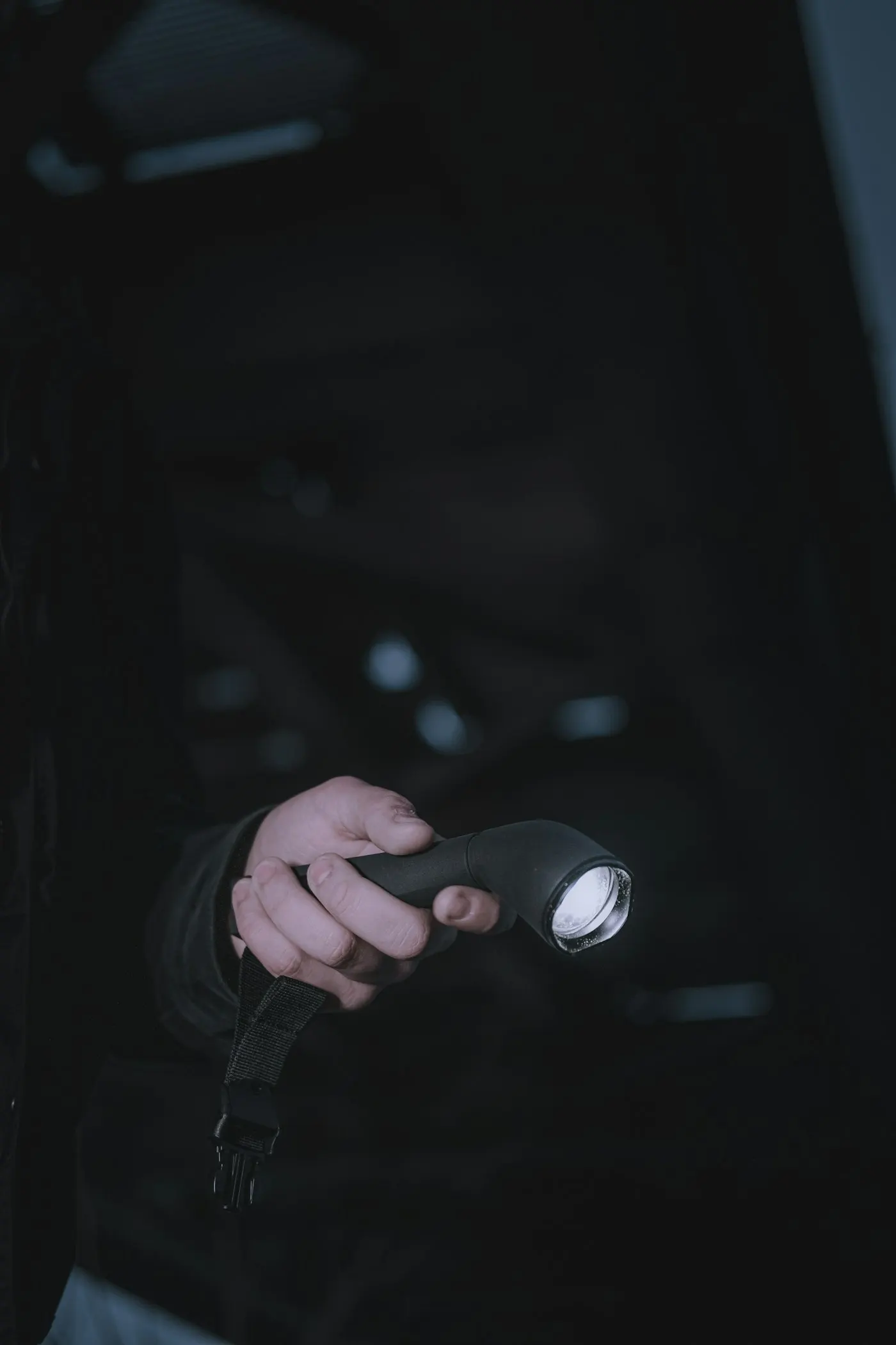 Hands checking off items on an emergency supply list with a flashlight